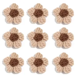 Close-up detail of handmade crochet flower applique, cute beige and brown knit DIY accessory.