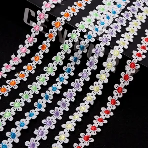 Detailed view of colorful embroidered small daisy lace trim for DIY crafting and decor.