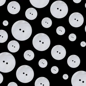 Close-up detail of white mother-of-pearl shell buttons, ideal for shirts and sewing crafts.