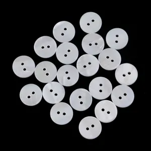 Detail view of natural white shell buttons with 2 holes, featuring pearlescent texture.