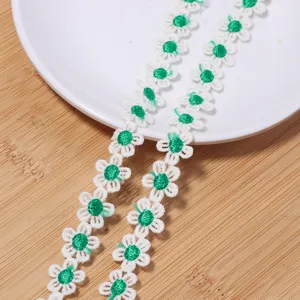 White and green daisy lace trim detail, delicate floral embroidery for DIY clothing and crafts.