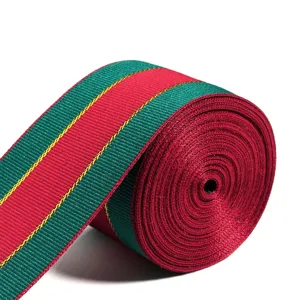 Close-up view of a red and green Christmas ribbon roll featuring elegant gold metallic details.