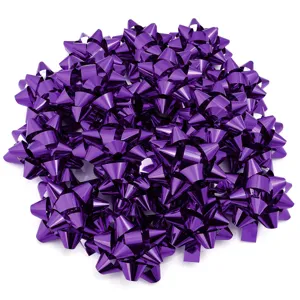 Purple metallic star ribbon bows for gift wrapping and holiday party decoration detail shot.