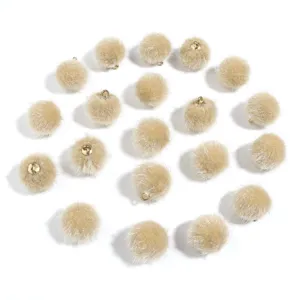 Beige faux fur pom poms with gold loops, DIY craft charms for keychains and earrings.