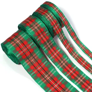 Red green plaid Christmas ribbon close-up, festive tartan fabric webbing for gift wrapping.