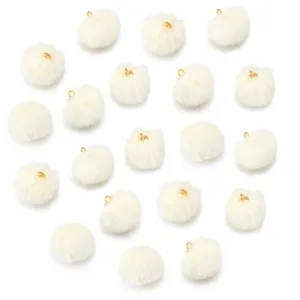 Fluffy white faux fur pom pom charms with gold loops for DIY jewelry, keychains and bags.