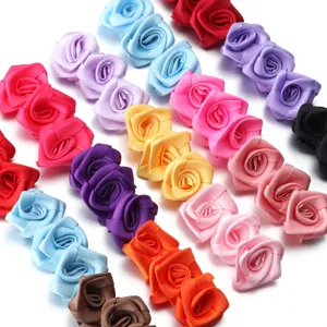 Handmade satin ribbon rose flowers, colorful fabric floral accessories for DIY crafts.