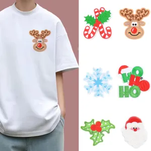 Close-up details of assorted Christmas embroidered iron-on patches for DIY clothing decor.