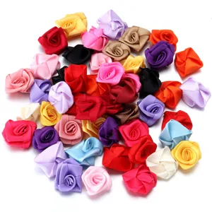 Assorted handmade ribbon roses detail shot, colorful fabric flower DIY accessories for crafts.