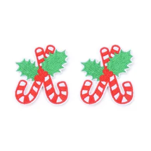 Close-up detail of Christmas candy cane embroidery patches with vibrant red and green holly.
