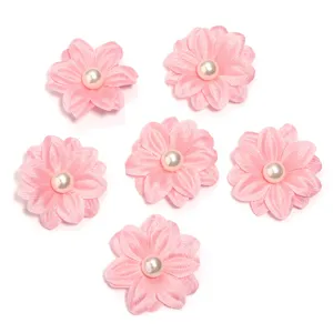 Detailed close-up of pink double-layer fabric flower DIY craft accessories with faux pearl.