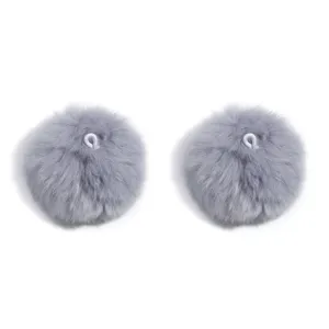 Close-up detail of fluffy grey pom pom furry accessories with elastic loop for hanging decor.