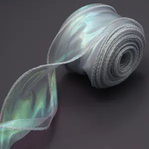 Close-up detail of iridescent wavy organza ribbon rolls, showing shimmering holographic texture.