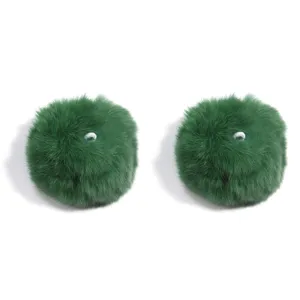 Green fluffy fur pom pom charms with white elastic loops, perfect for keychains and accessories.