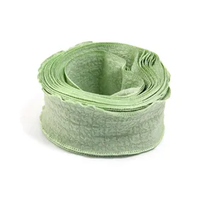 Close-up detail of light green ruffled bubble crinkle ribbon trim, ideal for handmade crafts.