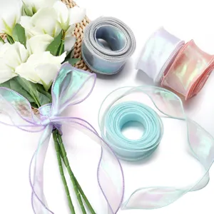 Detailed close-up of iridescent wavy organza ribbons in various colors with a flower bouquet.