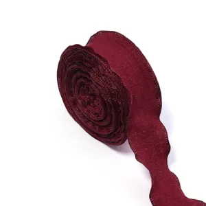 Close up detail view of burgundy ruffled pleated ribbon showing the exquisite fine texture.