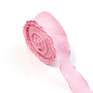 Pink ruffled bubble crepe ribbon detail, textured edge for gift wrapping and DIY crafts.