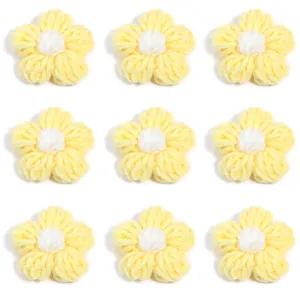 Close-up details of handmade yellow crochet yarn flowers, perfect for DIY craft accessories.