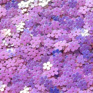 Closeup view of shiny purple flower sequins, perfect for DIY nail art and craft projects.