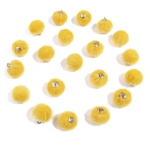 Yellow faux fur pompom charms with metal hanging loops, perfect for DIY jewelry and accessories.