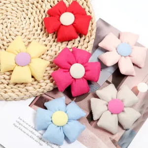 Close-up detail of cute 3D stuffed fabric five-petal flower accessories, colorful DIY patch.