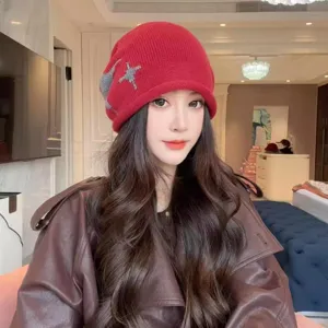Red winter knitted beanie for women featuring a stylish star cross pattern, soft warm slouchy hat.