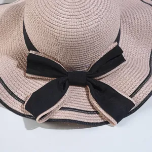 Detailed view of women summer straw sun hat featuring black bow and elegant wavy brim.