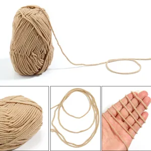 Close-up details of beige milk cotton yarn ball, soft texture and even thickness for DIY crafts.