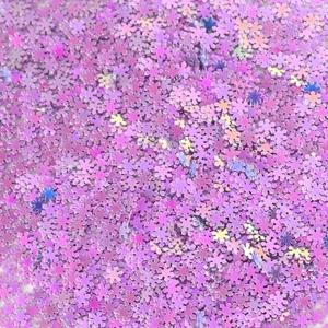 Close-up of holographic purple snowflake sequins, perfect for nail art and DIY crafts details.