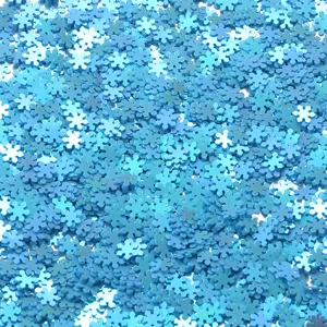 Blue snowflake PVC sequins close-up, non-hole glitter for nail art, DIY crafts and clothing accessories.