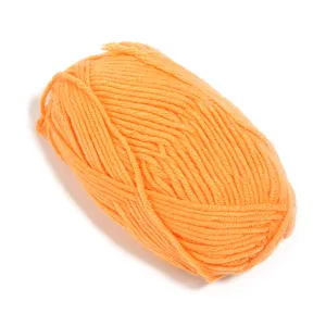 Orange milk cotton yarn ball detail, soft texture close-up for knitting and DIY handmade crafts.