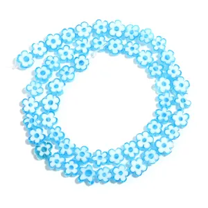 Blue white flower bead detail shot, DIY jewelry accessory close up for handmade craft.