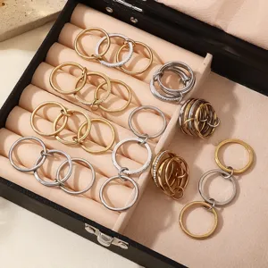 Detailed shot of multi-layer stackable interlocking rings in gold and silver stainless steel.
