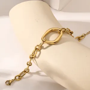 Close-up detail of minimalist irregular geometric gold-tone stainless steel chain bracelet link.