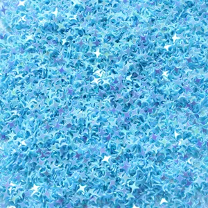 Close-up detail of light blue PVC four-pointed star sequins for nail art and crafts DIY.