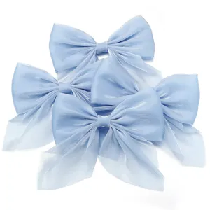 Light blue chiffon pearlescent bow detail, delicate hair accessory and clothing trim.
