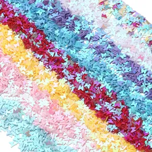 Close-up detail of colorful butterfly PVC sequins for nail art and DIY handmade crafts.