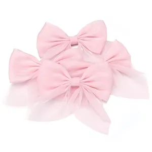 Pink organza pearlescent bow detail shot, sheer ribbon hair accessory and clothing trim.