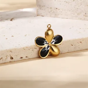 Close-up detail of gold stainless steel black enamel flower pendant charm for DIY jewelry crafting.