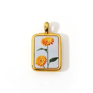 Gedetailleerd overzicht van een vintage retro stijl goudomrande rechthoekige bloemhars hanger.