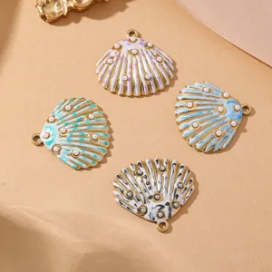 Close-up detail shot of four colorful enamel shell charms with pearl accents for DIY jewelry making.