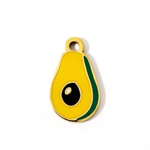 Detail view of cute avocado enamel pendant, glossy gold tone metal DIY jewelry part.