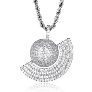 Detailed shot of iced out globe pendant necklace featuring pavé cubic zirconia on silver metal.