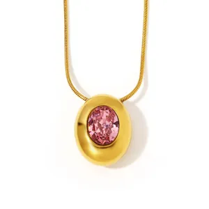 Elegant gold snake chain necklace featuring a chunky oval pendant with sparkling pink zirconia.