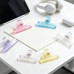 Colorful translucent plastic binder clips for office stationery and notes organization.