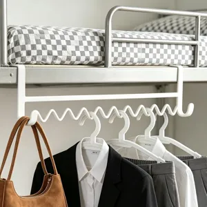 Detailed view of white over-bed hanging hook installed on bunk bed for smart dorm room storage.