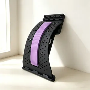 Detailed view of the black and purple back stretcher and lumbar support device for fitness yoga.