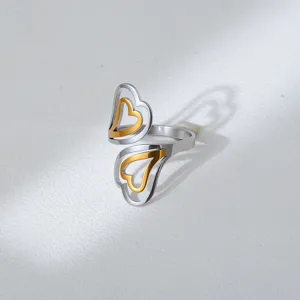 Two-tone stainless steel open ring detail, interlocking double heart design, modern fashion.