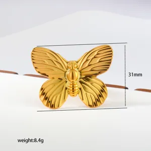 Gold butterfly ring detail view, adjustable stainless steel geometric finger jewelry feature.